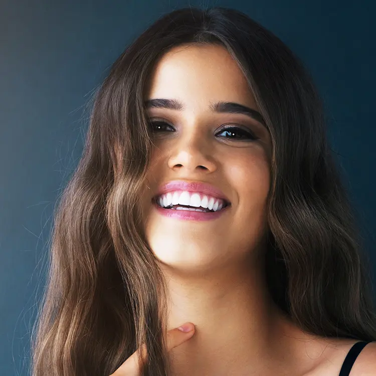 Woman Smiling After Having Porcelain Veneers Procedure