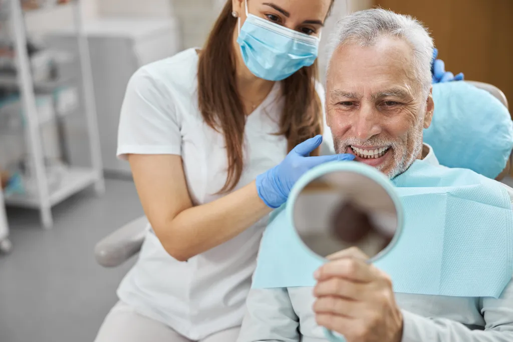 Hygienist Showing Bronx Patient Clean Smile In Mirror
